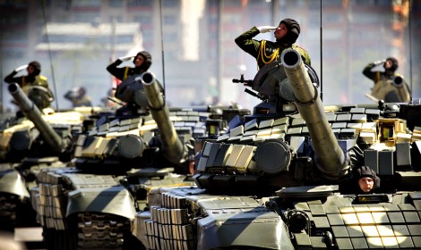 Belarussian servicemen salute from tanks, as they take part in a